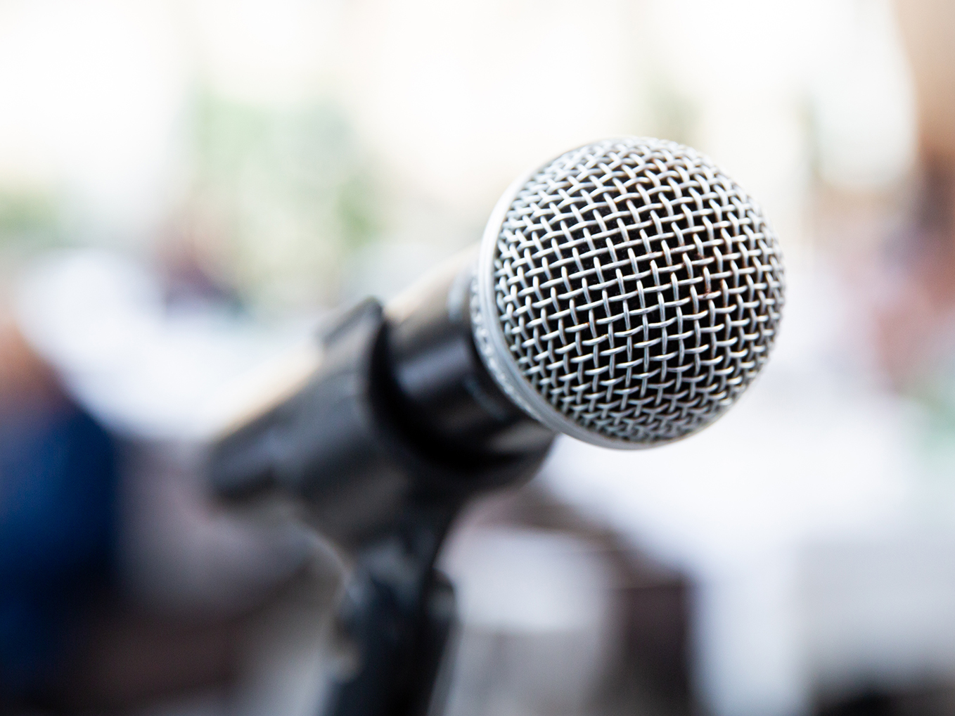 tight close up shot of a microphone against a blurred background